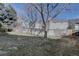 Private backyard with large trees and wood fence at 14656 W Vassar Dr, Lakewood, CO 80228