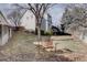 Spacious, fenced backyard with mature trees and a seating area at 14656 W Vassar Dr, Lakewood, CO 80228