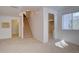 Spacious basement area features neutral carpeting, a window, and staircase to upper level at 14656 W Vassar Dr, Lakewood, CO 80228