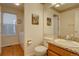 Bathroom features a vanity with granite countertop and updated toilet at 14656 W Vassar Dr, Lakewood, CO 80228