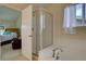 Bathroom featuring a shower with glass door and a bathtub at 14656 W Vassar Dr, Lakewood, CO 80228