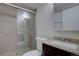Modern bathroom featuring a glass-enclosed shower and sleek vanity with stylish fixtures at 14656 W Vassar Dr, Lakewood, CO 80228