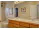 Bathroom vanity area with double sinks, tile countertop and a view of the bath/shower at 14656 W Vassar Dr, Lakewood, CO 80228