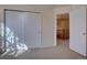 Empty bedroom with a closet and a view of the staircase at 14656 W Vassar Dr, Lakewood, CO 80228