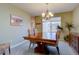 Dining room featuring an elegant chandelier and a large table perfect for Gathering gatherings at 14656 W Vassar Dr, Lakewood, CO 80228