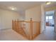 Upstairs hallway with railing and neutral carpet leads to bedrooms at 14656 W Vassar Dr, Lakewood, CO 80228