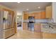 Updated kitchen showcases stainless steel appliances, granite counters, and hardwood flooring at 14656 W Vassar Dr, Lakewood, CO 80228