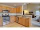 Modern kitchen has granite countertops, stainless steel appliances, and convenient open layout to living room at 14656 W Vassar Dr, Lakewood, CO 80228