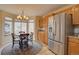 Kitchen nook featuring stainless steel refrigerator and sunny breakfast area by a bright window at 14656 W Vassar Dr, Lakewood, CO 80228