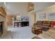 Spacious living area features vaulted ceilings, fireplace, and open concept layout to the kitchen at 14656 W Vassar Dr, Lakewood, CO 80228