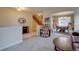 Open-concept living area with access to the dining room and staircase at 14656 W Vassar Dr, Lakewood, CO 80228