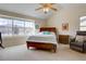 Bright main bedroom featuring vaulted ceilings, ceiling fan and large windows with mountain views at 14656 W Vassar Dr, Lakewood, CO 80228