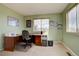 Bright home office features a large window, desk, and office furniture at 14656 W Vassar Dr, Lakewood, CO 80228