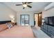 Bedroom with access to the patio and attached bathroom, featuring a ceiling fan at 9556 W 89Th Cir, Broomfield, CO 80021