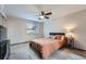 Cozy bedroom featuring a ceiling fan, carpeted floors and a side table at 9556 W 89Th Cir, Broomfield, CO 80021