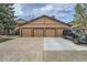 Four-car garage featuring brown doors and driveway, offering ample parking space at 9556 W 89Th Cir, Broomfield, CO 80021