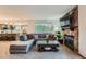 Comfortable living room with sectional sofa, stone fireplace, and an open layout to kitchen at 9556 W 89Th Cir, Broomfield, CO 80021