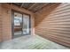 Outdoor patio space featuring wood paneling and sliding glass door, offering a private retreat at 9556 W 89Th Cir, Broomfield, CO 80021