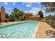 Community pool surrounded by lush greenery and mature trees, offering a refreshing escape at 9556 W 89Th Cir, Broomfield, CO 80021