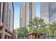 View of high-rise condo building with surrounding architecture and green trees at 1777 Larimer St # 1203, Denver, CO 80202