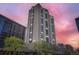 View of the exterior of the high rise condo building during sunset against a colorful sky at 1777 Larimer St # 1203, Denver, CO 80202