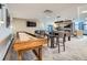 Condo game room features a shuffleboard table, fireplace, TV, modern lighting, and neutral color palette at 1777 Larimer St # 1203, Denver, CO 80202