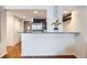 Stylish kitchen featuring a breakfast bar, stainless steel appliances and hardwood floors at 1777 Larimer St # 1203, Denver, CO 80202