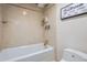 Bathroom shower is updated with floor to ceiling tile, storage and modern shower head at 1777 Larimer St # 1203, Denver, CO 80202