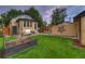 Charming backyard with lawn, brick house, and patio seating at 1172 Harrison St, Denver, CO 80206