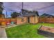 Landscaped backyard with grass, shed, string lights, and wooden fence at 1172 Harrison St, Denver, CO 80206