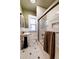 Clean bathroom with subway tile shower, pedestal sink and hexagon tile floors at 1172 Harrison St, Denver, CO 80206