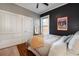 Bedroom shows closet space, wooden floors, minimalist decor, and natural light at 1172 Harrison St, Denver, CO 80206