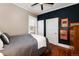 Bedroom features wood floors, unique wall art, and a comfortable layout at 1172 Harrison St, Denver, CO 80206