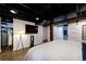 Bright bedroom with black ceiling, recessed lighting, sliding barn doors, and wall-mounted television at 1172 Harrison St, Denver, CO 80206