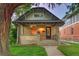 Charming brick home with a welcoming porch and a well-manicured lawn at 1172 Harrison St, Denver, CO 80206