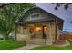 Charming brick home with a covered front porch and green lawn at 1172 Harrison St, Denver, CO 80206