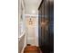 Hallway with wooden floors, built in black shelving and a peek at the basement access at 1172 Harrison St, Denver, CO 80206