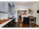 Stylish kitchen with white subway tile, open shelving, and modern appliances at 1172 Harrison St, Denver, CO 80206