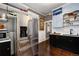 Kitchen boasts stainless steel refrigerator and a seamless design with open shelving at 1172 Harrison St, Denver, CO 80206
