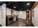 Basement Laundry area with modern washer and dryer, finished ceiling, and polished concrete floors at 1172 Harrison St, Denver, CO 80206