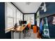 Bright office space with multiple windows, wood floors, and custom shelving at 1172 Harrison St, Denver, CO 80206