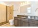 Well-lit bathroom showcasing a vanity with granite counters, stylish light fixtures, and a tiled walk-in shower at 497 Valley Way, Bennett, CO 80102