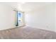 Bright bedroom with neutral carpet and a window offering natural light and exterior views at 497 Valley Way, Bennett, CO 80102