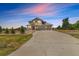Two-story home with a large driveway, three-car garage, stone accents and well-manicured landscaping at 497 Valley Way, Bennett, CO 80102