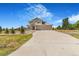 Inviting two-story home featuring a three car garage and landscaped front yard at 497 Valley Way, Bennett, CO 80102