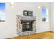 Living room fireplace with decorative stone and a wall mounted bracket at 497 Valley Way, Bennett, CO 80102