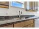 Kitchen sink, stainless steel, with granite counter tops and wood cabinets at 497 Valley Way, Bennett, CO 80102