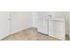 A tidy laundry room with a modern white washer and dryer and tiled floors at 497 Valley Way, Bennett, CO 80102