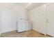 Well-lit laundry room with modern washer and dryer, tiled floors, and a white door at 497 Valley Way, Bennett, CO 80102