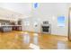 Spacious living room with hardwood floors, fireplace, and large windows at 497 Valley Way, Bennett, CO 80102